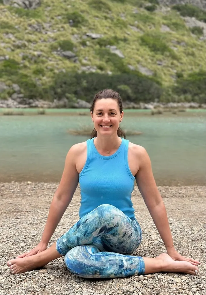 Diana smiling beside a mountain lake